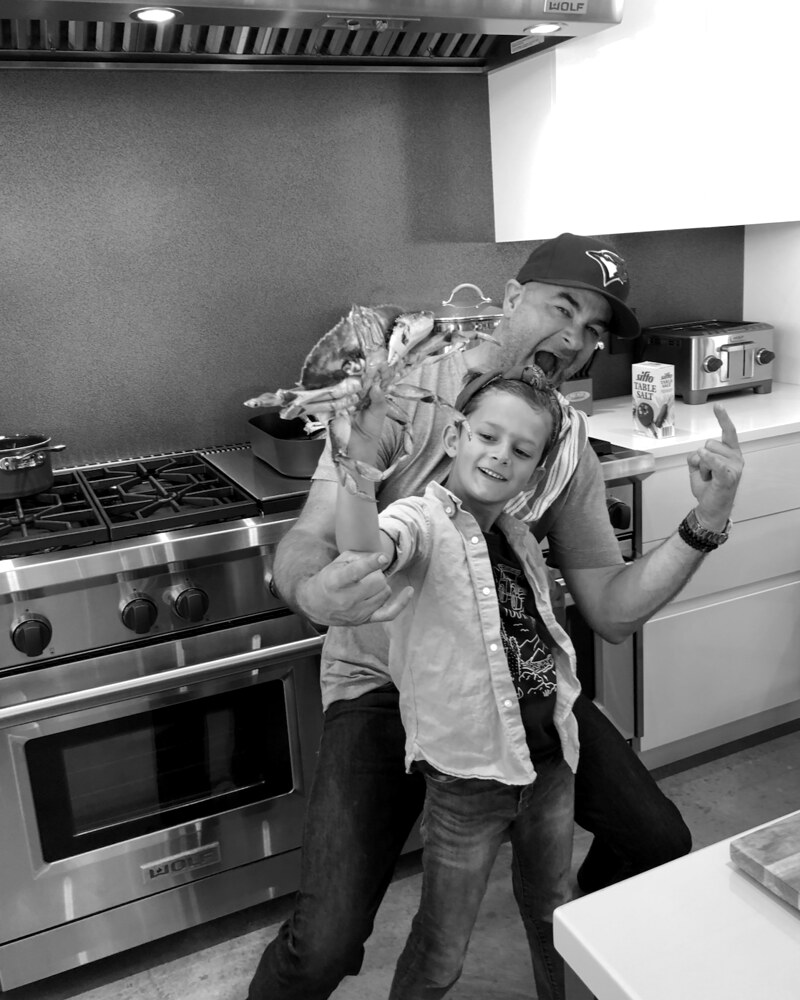 Father and son in the kitchen with fresh crab